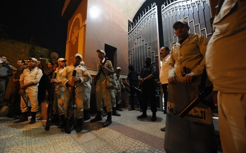 Egyptian security forces stand guard at a Coptic Christian church in the Waraa neighborhood of Cairo