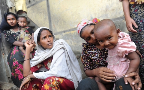 A Muslim Rohingya family sits outside their temporary relief camp in a school in Thetkaepyin village.