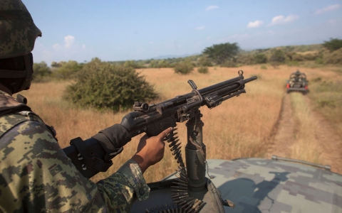 A soldier patrols in an army convoy in Michoacan state, Mexico. Knights Templar, a quasi-religious drug cartel that controls the area and most of the state