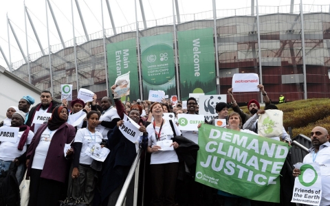 Members of NGOs walk out of United Nations Climate Change Conference COP 19 in Warsaw on November 21, 2013. They protested as they claim were