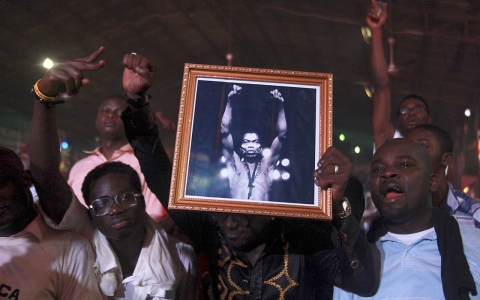 Felabration attendees hold up a photograph of Fela Kuti, the late Nigerian musician