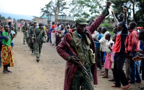 A Congolese army soldier responds to cheers from civilians as the army enters the town of Bunagana, eastern Congo, near the border with Uganda, Wednesday.