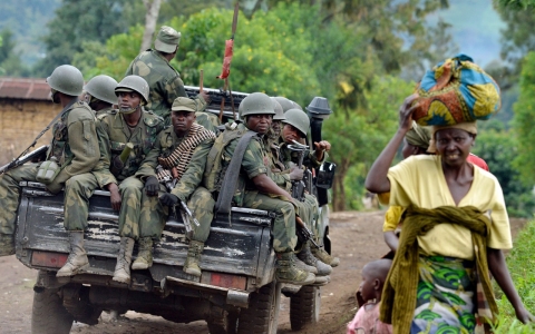 Democratic Republic of Congo soldiers sit in the back of a truck on Nov. 4, 2013 after recapturing a hilltop area from a rebel group.