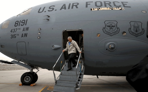 U.S. Secretary of Defense Chuck Hagel disembarks from a C-17 military aircraft on Saturday, Dec. 7, 2013