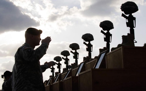 A soldier salutes memorial set up to victims of Ft. Hood shootings.