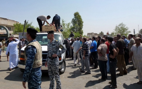 Iraqis attend the funeral of the victims of a suicide bombing.