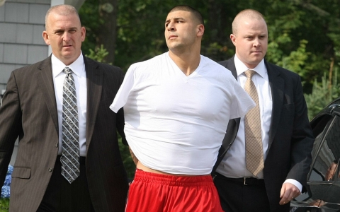 New England Patriots tight end Aaron Hernandez being taken out of his home in handcuffs in late June.