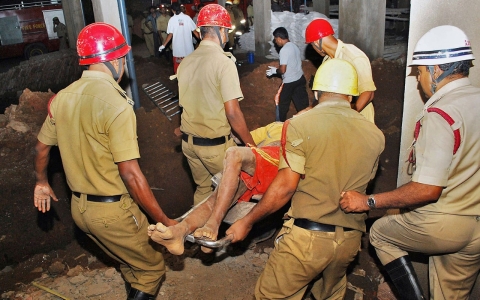 Policemen carry an injured man who was rescued from the rubble at the site of a collapsed building in the western Indian city of Goa on Saturday.