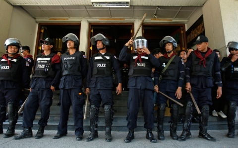 Police in riot gear guard a government building in Bangkok, Thailand to prevent anti-government protesters from blocking the entrance on Feb. 12, 2014.