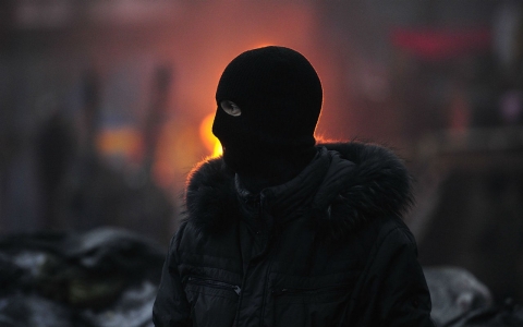 An anti-government protester gets ready to fight Berkut special police forces at a barricade Saturday in Kiev, Ukraine.