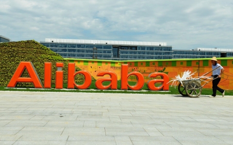 A worker walks past the Alibaba Group's office building at Alibaba Xixi Park in Hangzhou, China on Aug. 24, 2013.