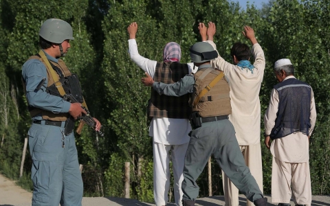 GHAZNI, June 13, 2014 (Xinhua) -- A policeman searches a person in Ghazni Province, Afghanistan, June 13, 2014. 