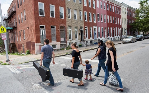 Mathew Loftus, left, walks home with his wife, Maggie, and daughter, Naomi