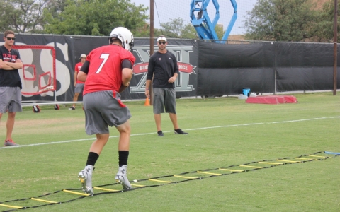 Kingsbury looks on as Webb, now the most experienced quarterback on the team, leads his teammates in the drills.