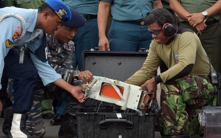 Divers retrieve AirAsia black box from beneath aircraft wing