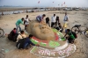 Students from Allahabad University and cricket fans make a sand sculpture of Tendulkar in Allahabad. 