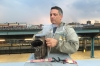 Andrew Coté lights a bee smoker on a rooftop in Bushwick, Brooklyn, where he keeps two bee hives.  The smoke is used to calm the bees. 