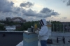 Ralph Gaeta tends to his beehives as the sun sets in Astoria, Queens, with a view of the Hell Gate Bridge in the background. 