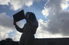 Molly Conley inspects her beehive in the West Village. She keeps two hives on the roof of the Historic Manhattan Seventh-day Adventist Church.